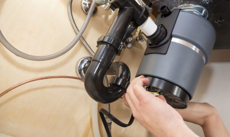 Garbage Disposal Repair Tampa plumber fixing kitchen disposal